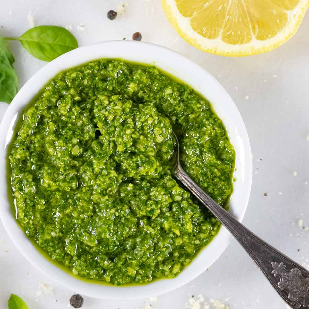 https://radfoodie.com/wp-content/uploads/2019/10/Pesto-without-pine-nuts-in-bowl-square-with-spoon.jpg