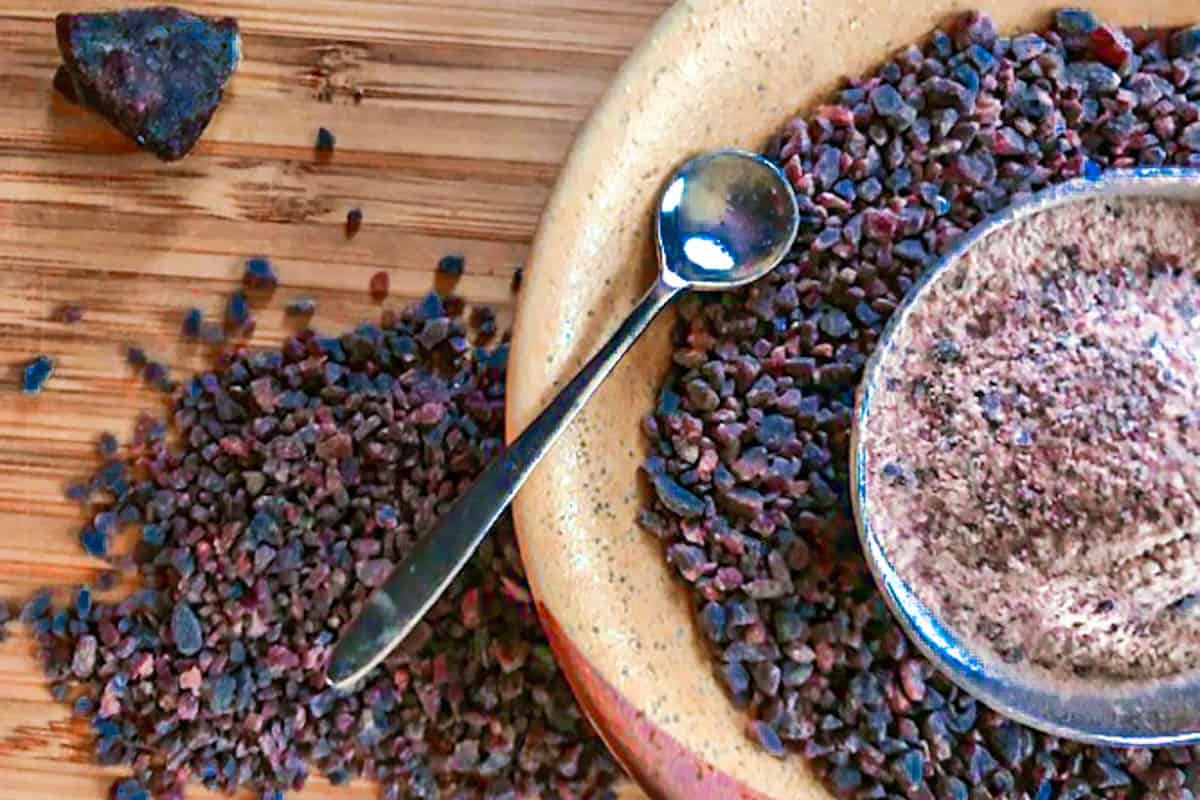 Black salt in earthenware dish and a small salt bowl with a salt spoon.