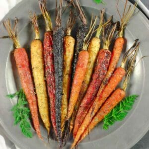 Plate of whole roast carrots.