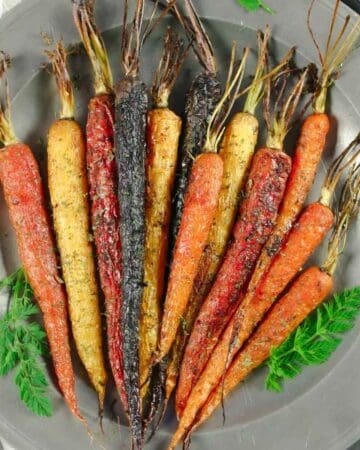 Plate of whole roast carrots.