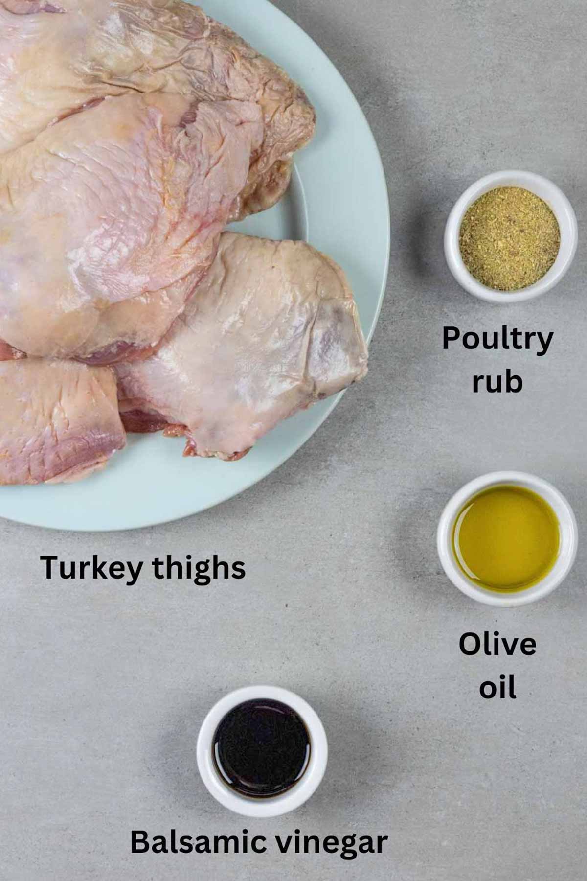 Ingredients for smoked turkey thighs on a board with black text labels.