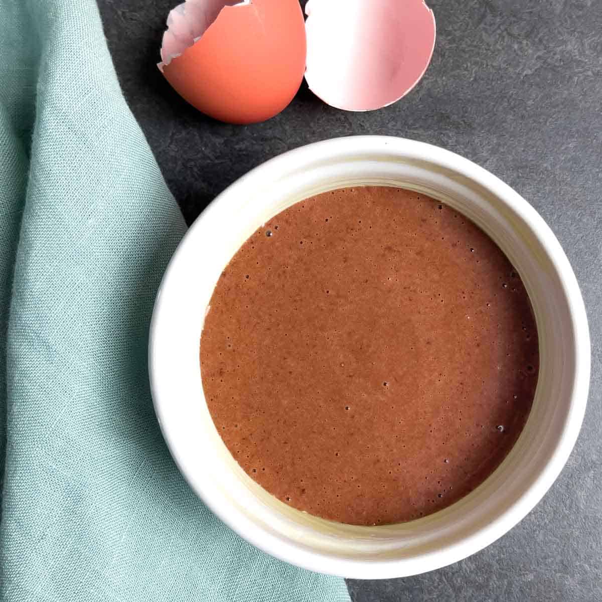 Cake batter in a ramekin.