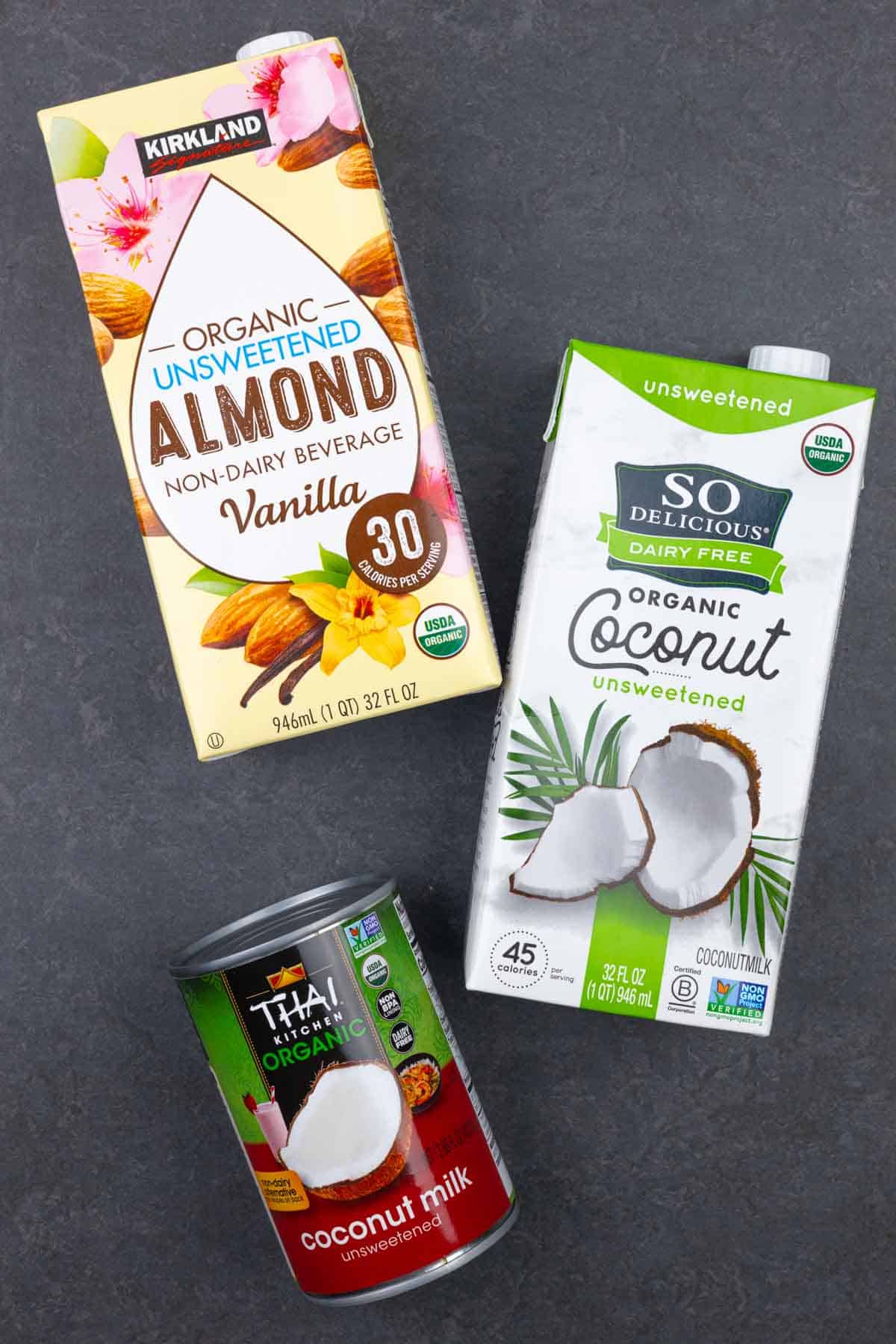 Packages of various dairy-free milks to use in keto eggnog including almond, canned and tetra packed coconut.