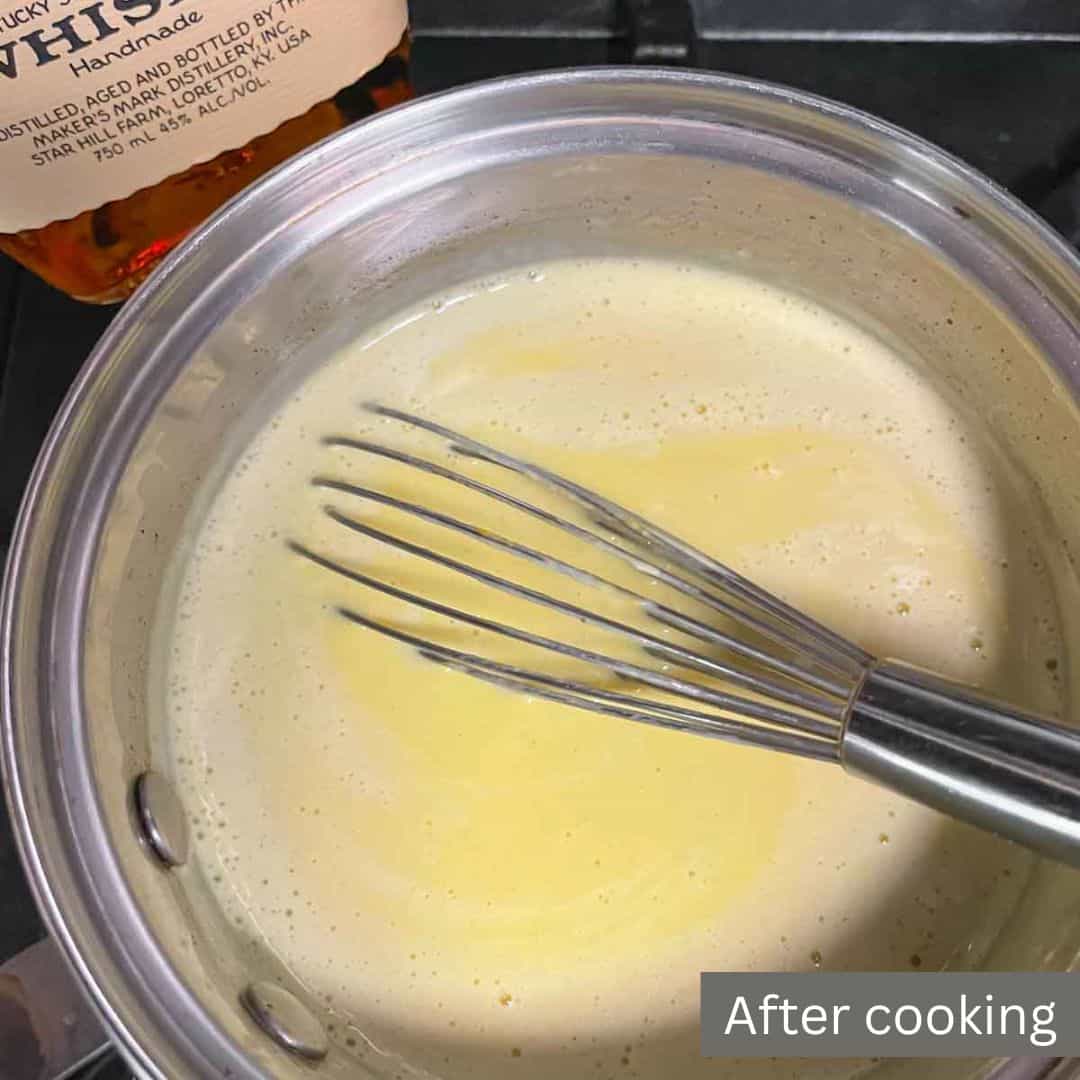 Ketogenic eggnog in a pot with a whisk with label showing it is after cooking.