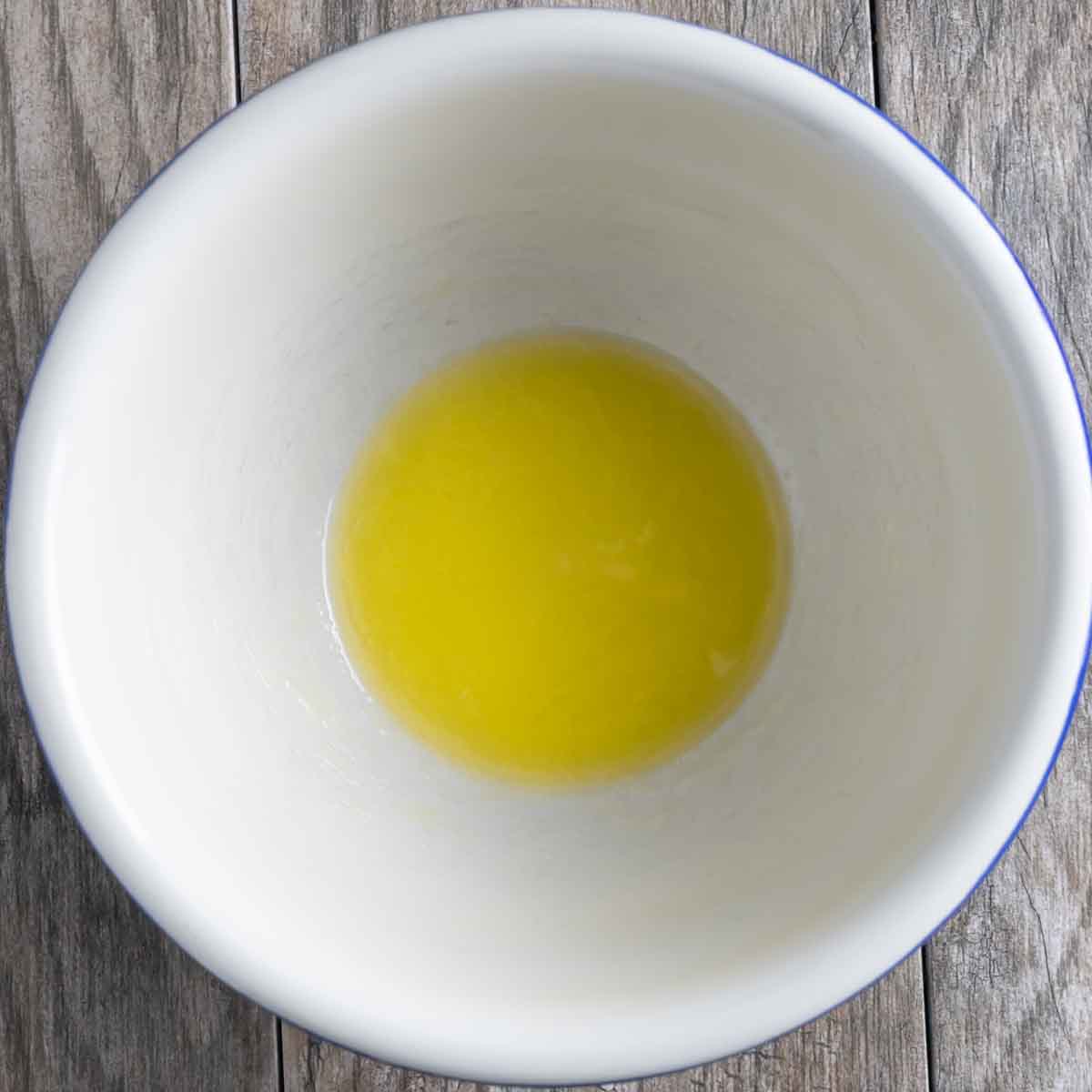 Melted butter in a white mixing bowl.
