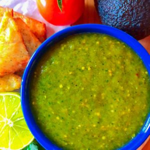 Tomatillo salsa verde in a blue bowl with a side of keto chips.