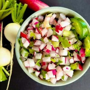 Bowl of radish salsa with whole radishes on the side.