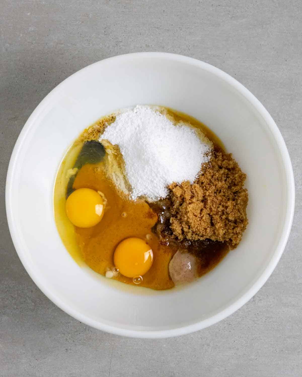 Ingredients for chocolate chip cookies in a white bowl pre-mixed.