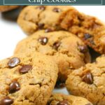 Pile of gluten free peanut butter chocolate chip cookies on a white background.