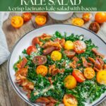 Cavolo nero kale blt salad with orange and red cut cherry tomatoes and bacon. Ramekin of dressing on the side with basket of tomatoes and plate of bacon.