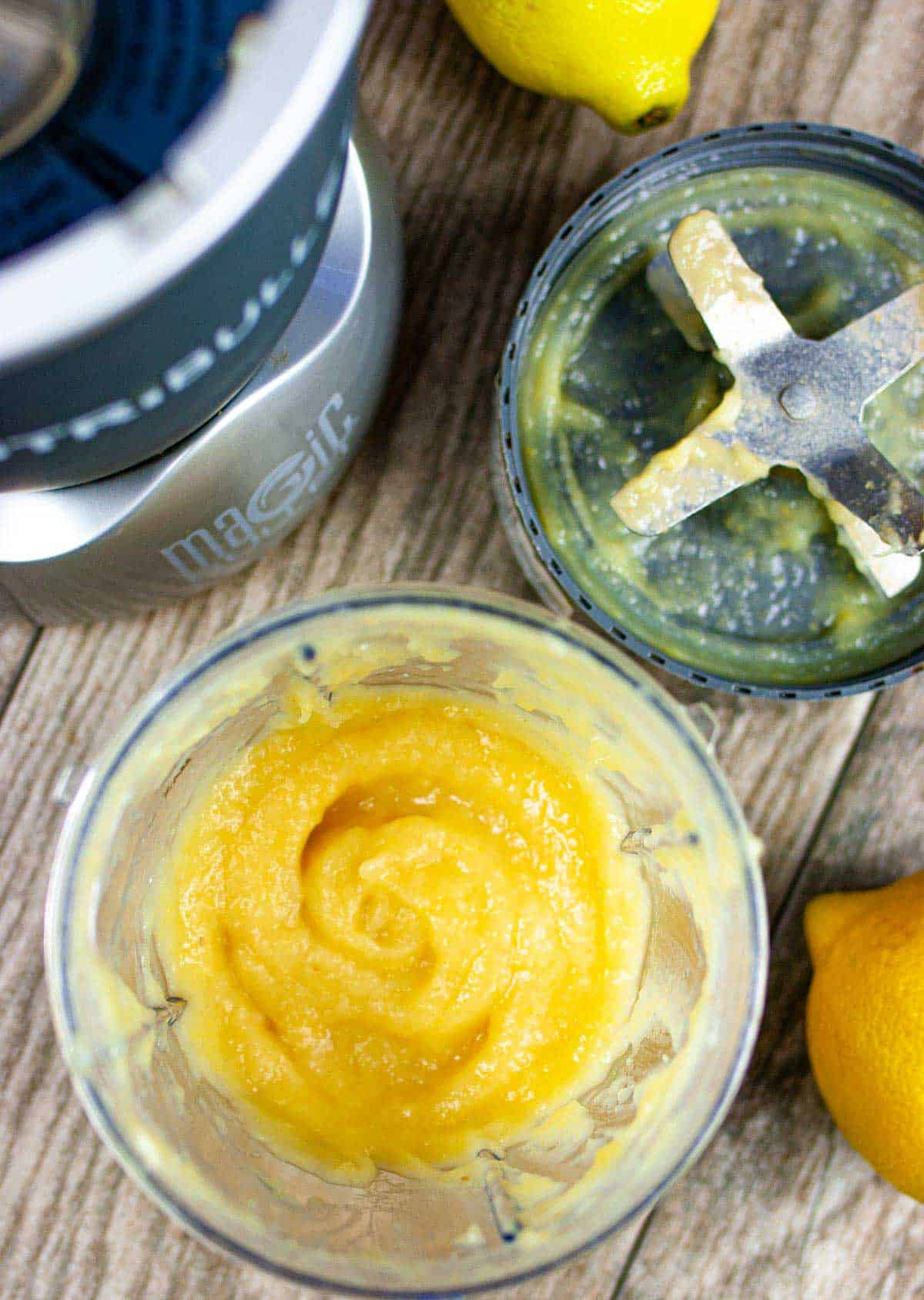 Lemon puree in the cup of a nutri-bullet blender with the lemony bottom blade attachment and machine next to it. 