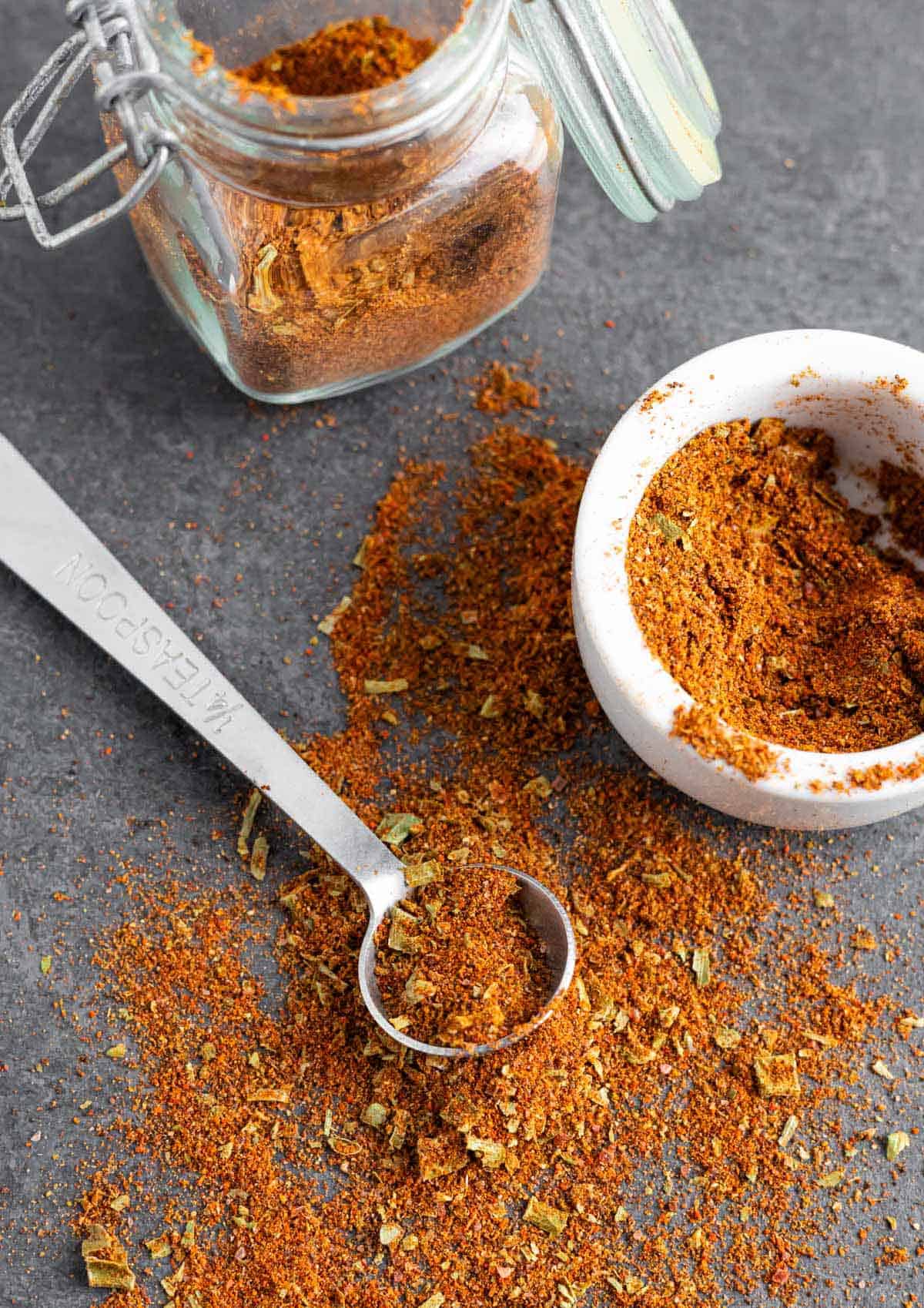 Pile of taco seasoning with some on a teaspoon.