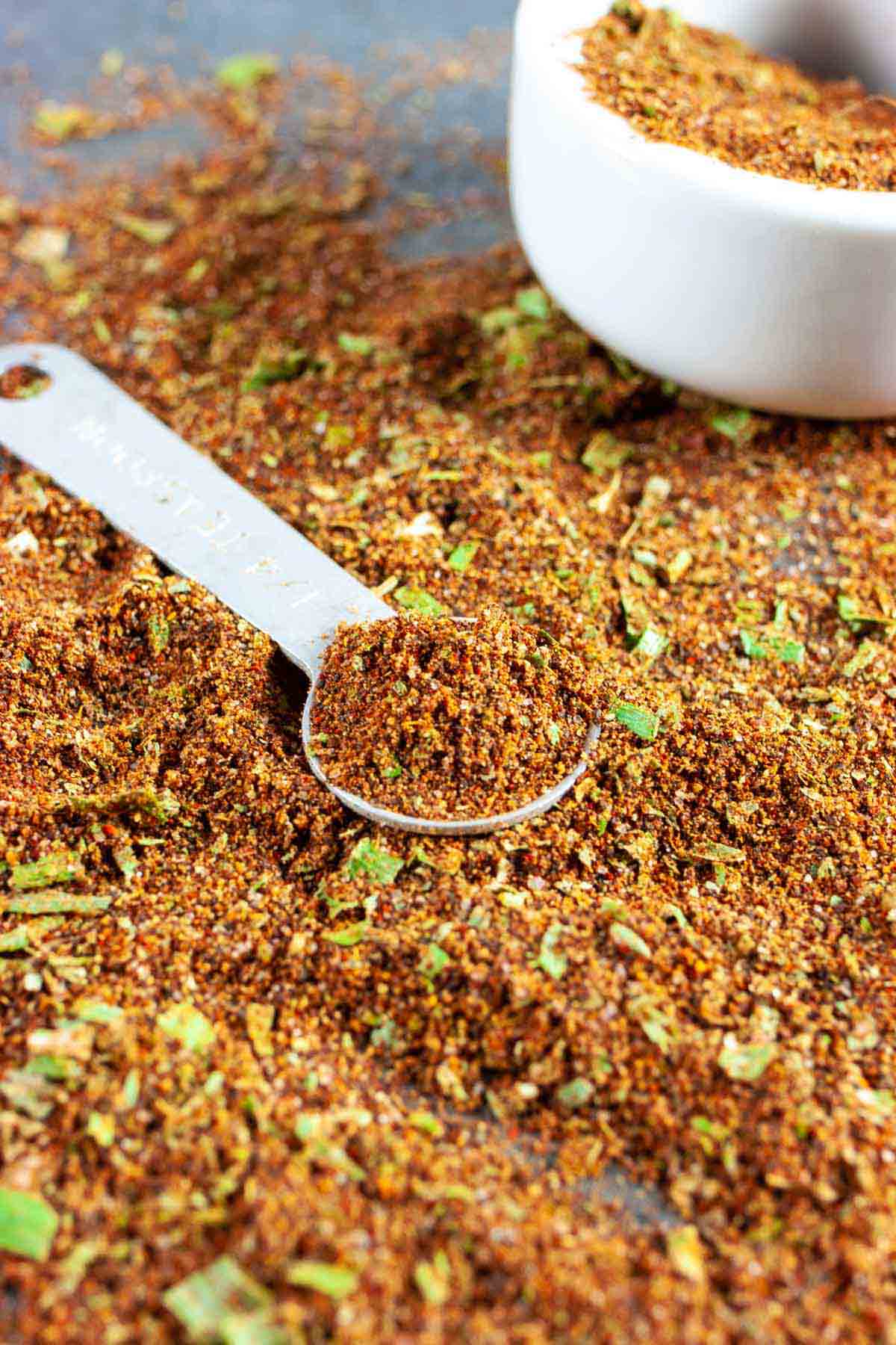 Pile of taco seasoning with some on a teaspoon.