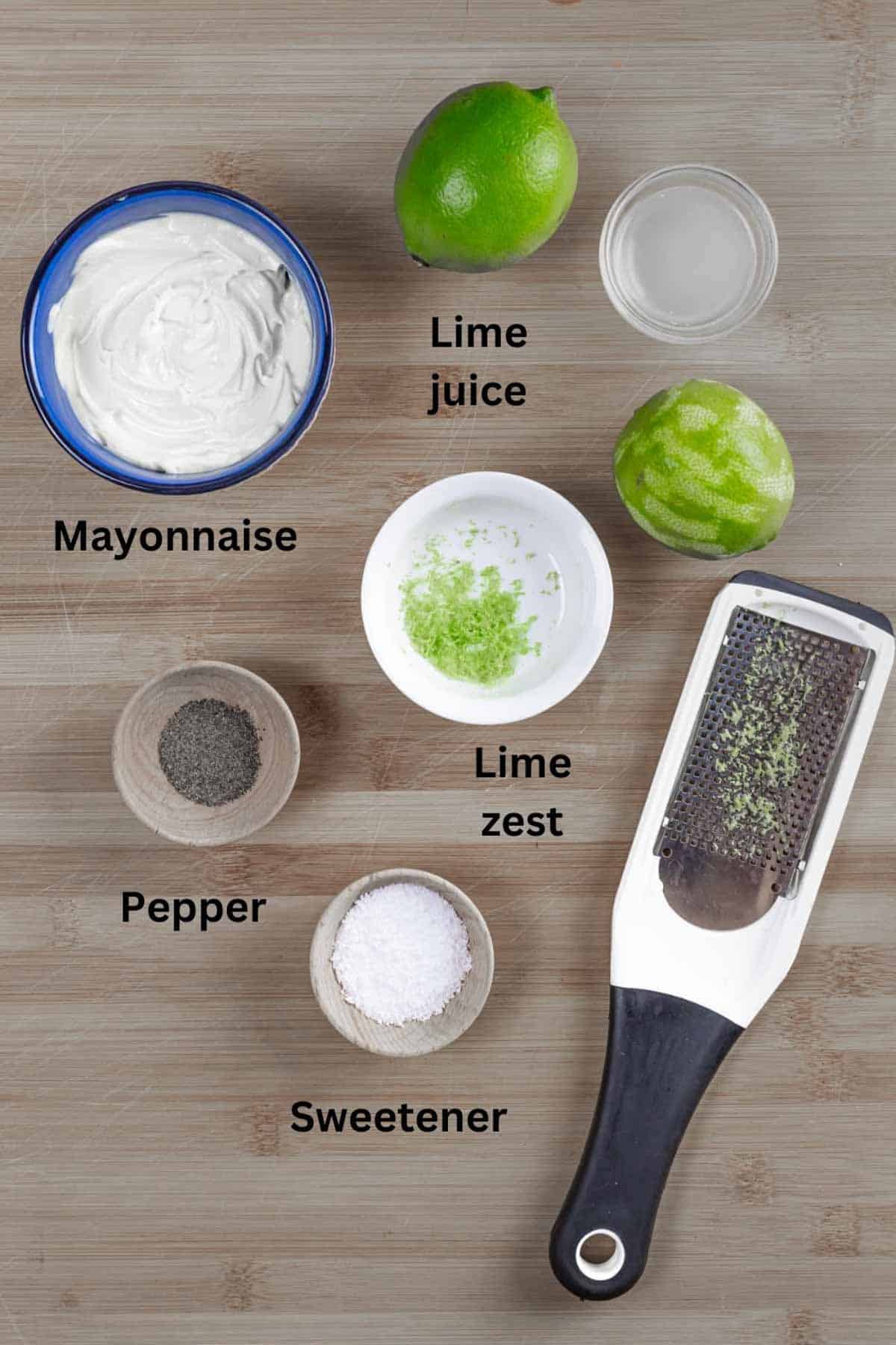 Ingredients for keto coleslaw dressing on a board with black text labels.