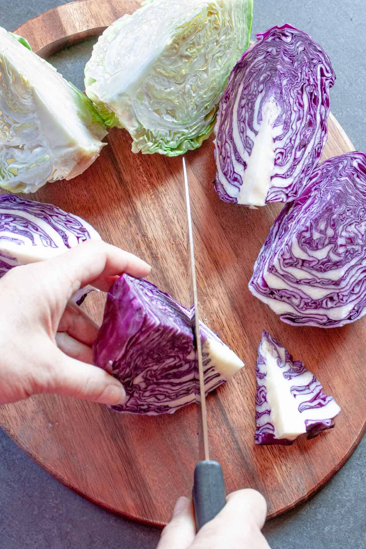 Red cabbage quarter of a head with the core being sliced off.
