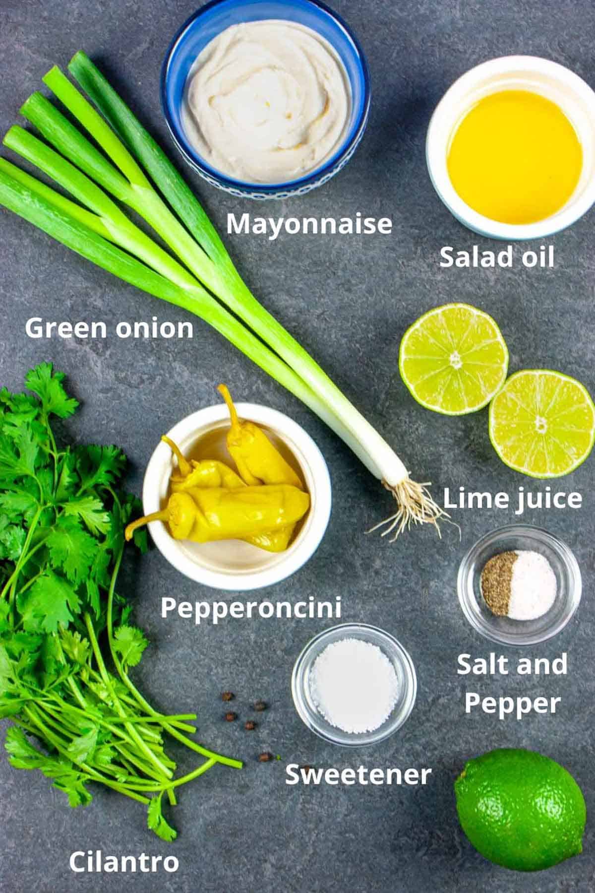 Dressing ingredients on a grey background and labelled.