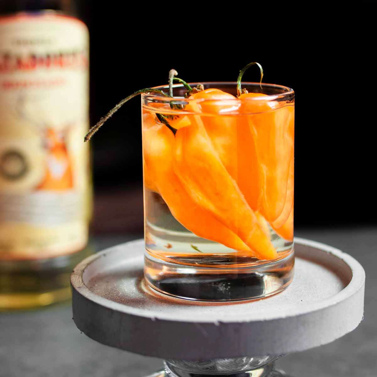 Habanero peppers in a glass of tequila.