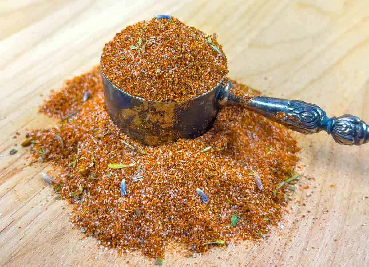 Pile of low fodmap barbeque rub on a board with a scoop full of rub sitting on the pile.
