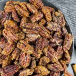 Bowl full of air fryer maple bourbon pecans.