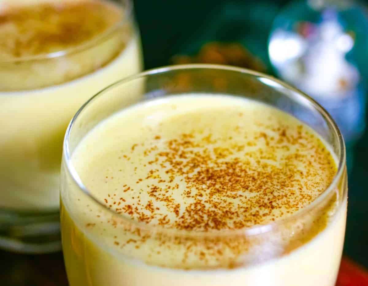 Glass of low carb eggnog without whip and sprinkled with cinnamon.