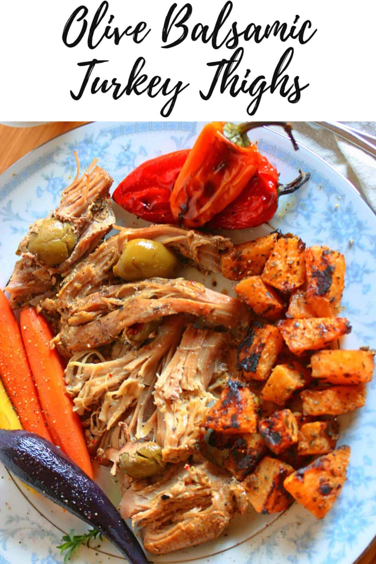 Plate of turkey thighs shredded with olives and balsamic and sides of carrots, peppers and rutabagas with a cursive label at the top.