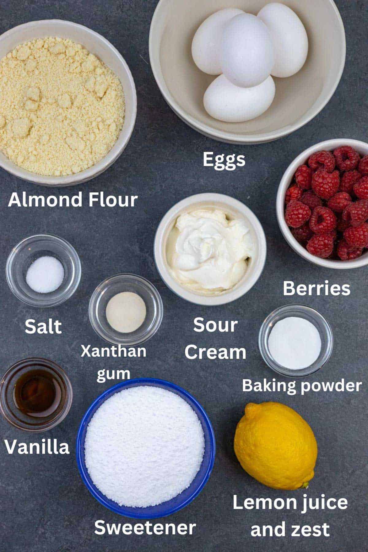 Small bowls of bundt cake ingredients on a dark grey board with white text labels.