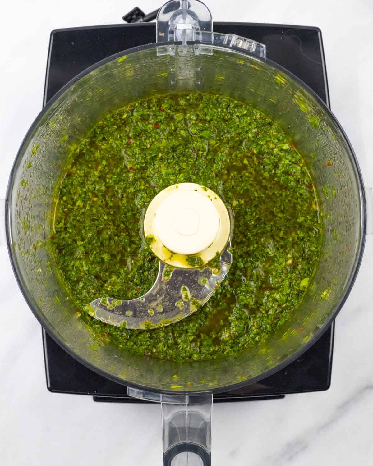 Blended Mexican chimichurri in food processor bowl.