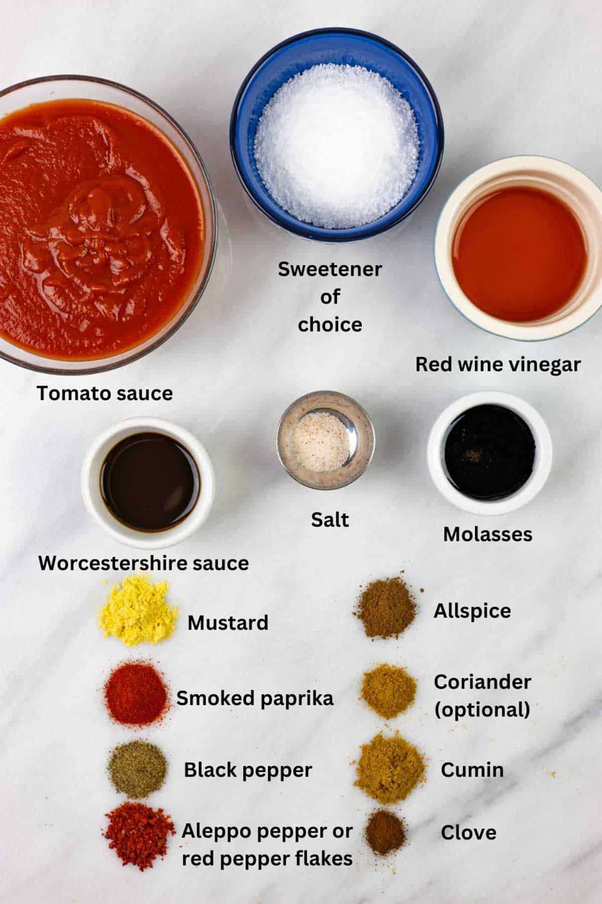Ingredients for low-fodmap barbecue sauce in bowls and small piles on a marble board with text labels.