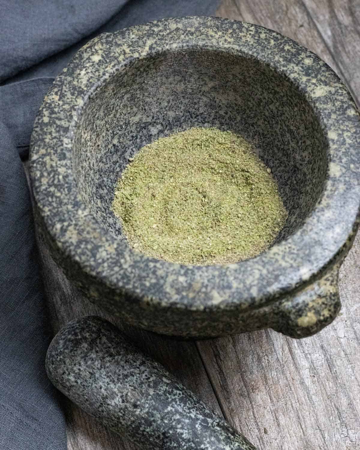 Finely ground seasoning in a granite mortar.