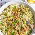 Tuna pesto pasta in a bowl with a forkful of noodles.