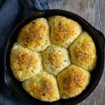 Golden almond flour dinner rolls baked in a small cast iron skillet.