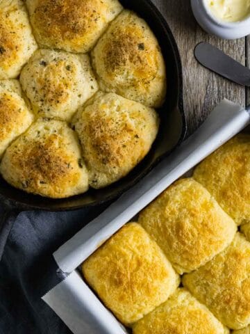 Gluten-free dinner rolls baked in a skillet, and a square baking pan.