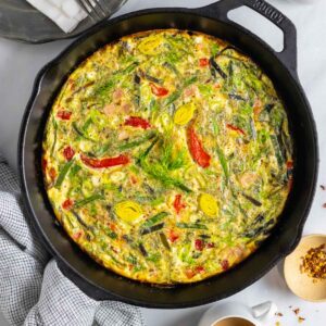 Dairy-free frittata with ham and leeks baked in a cast iron skillet.