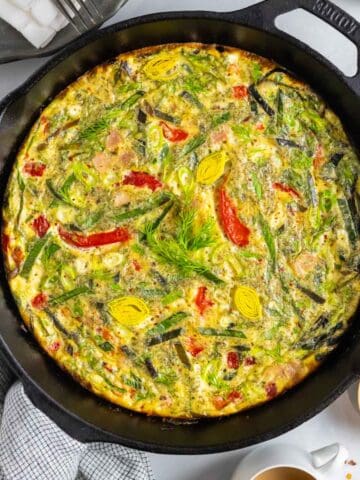Dairy-free frittata with ham and leeks baked in a cast iron skillet.