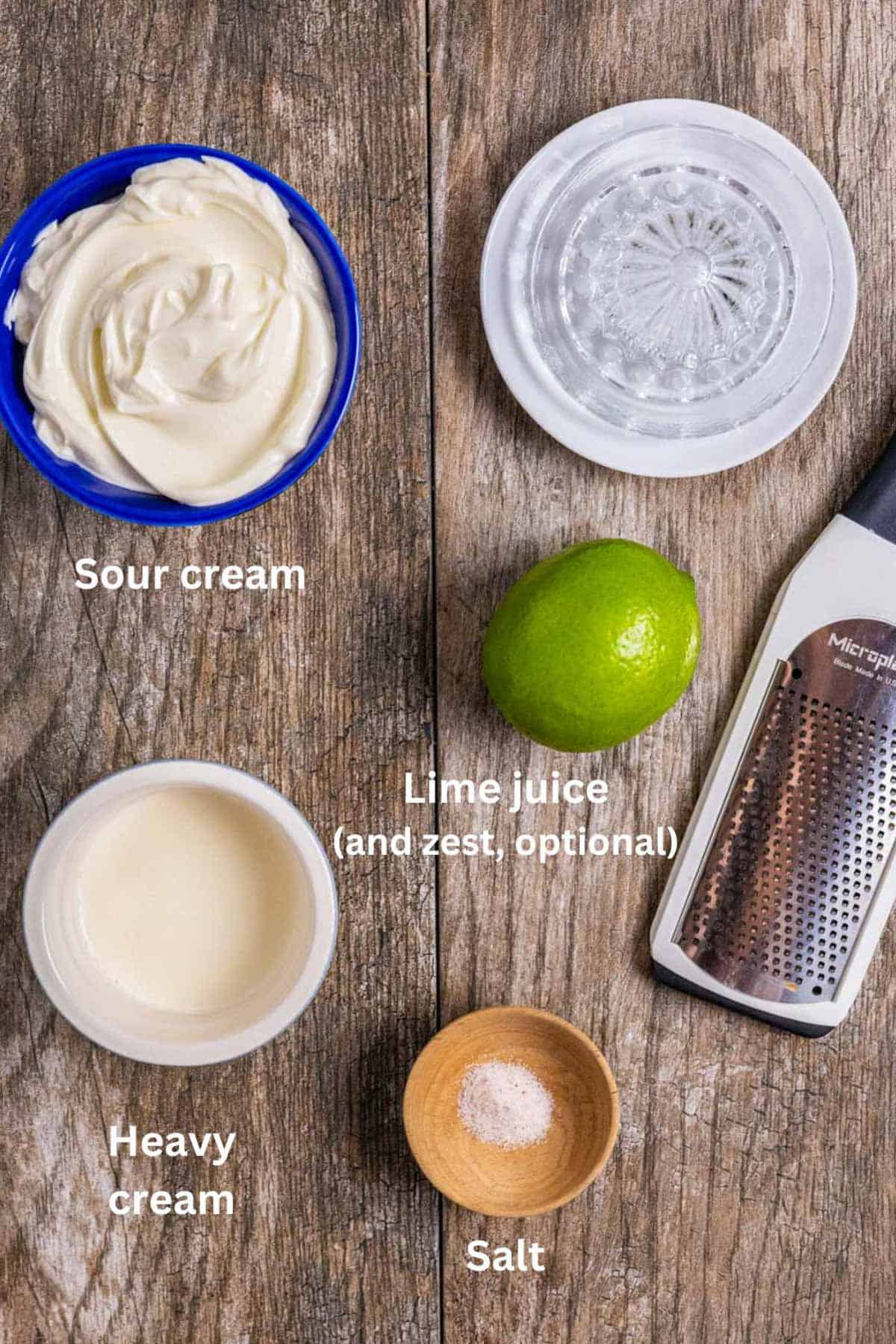 Ingredients for homemade crema on a wood board with white text labels.