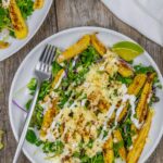 Salad plate of microgreen salad with roasted baby corn topped with crema.