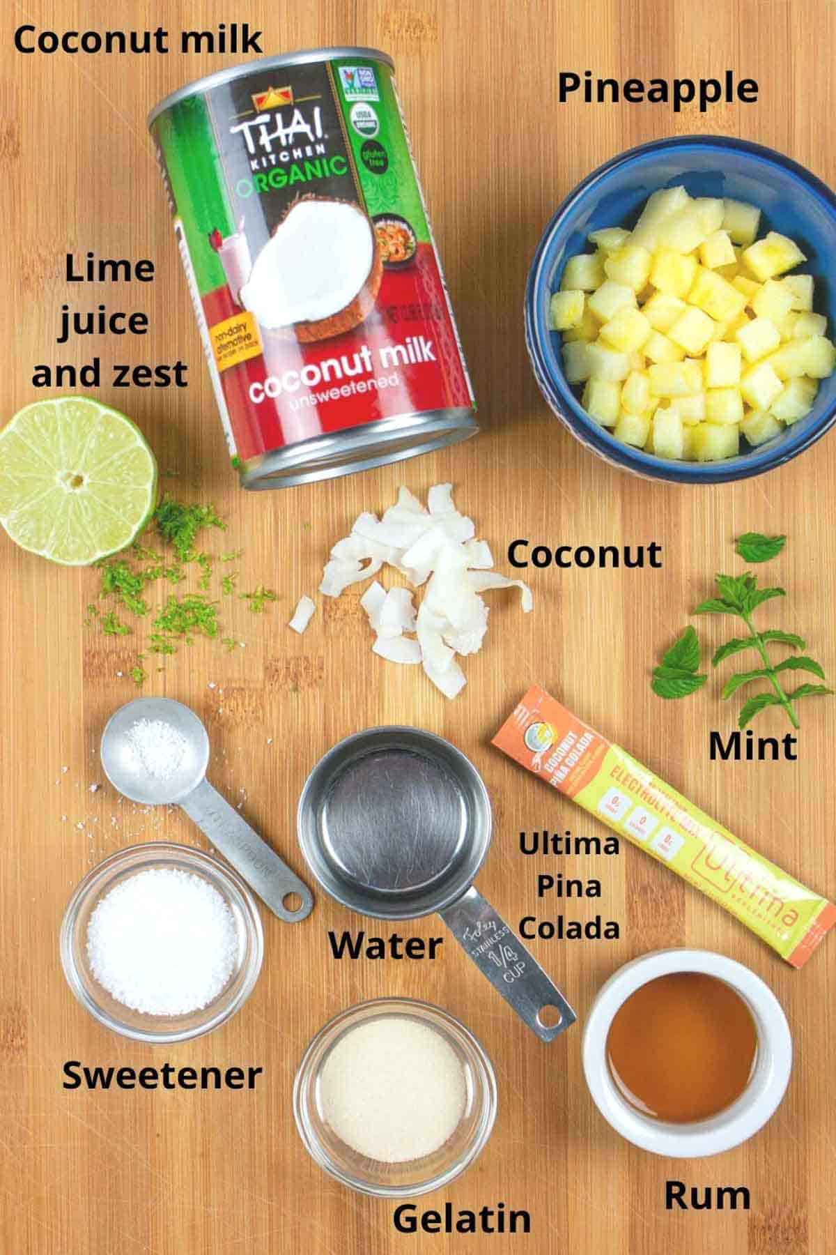 Ingredients for panna cotta on a bamboo board with black text labels.