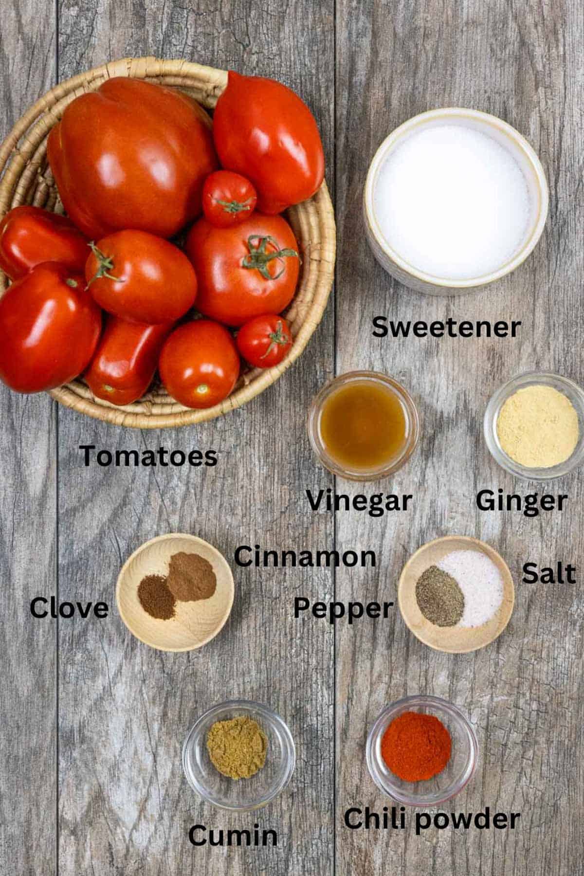 Ingredients for tomato jam with chili on a wood board with black text labels.