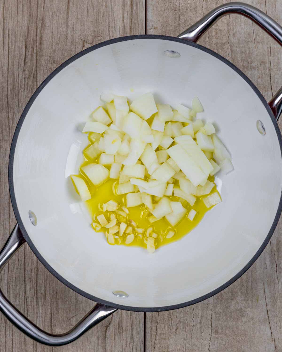 Oil, chopped garlic and onions in a soup pan ready to simmer.