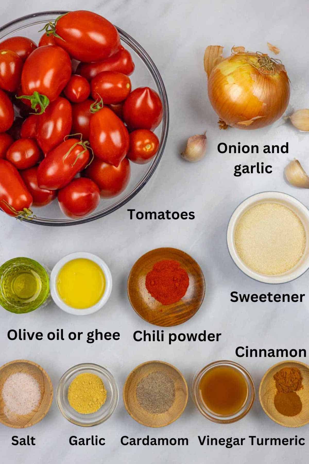 Fresh ingredients and spices for tomato onion chutney on a marble board with black text labels.