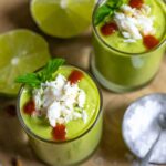 Gazpacho in 2 shot glasses topped with crab, mint leaves and cocktail sauce.