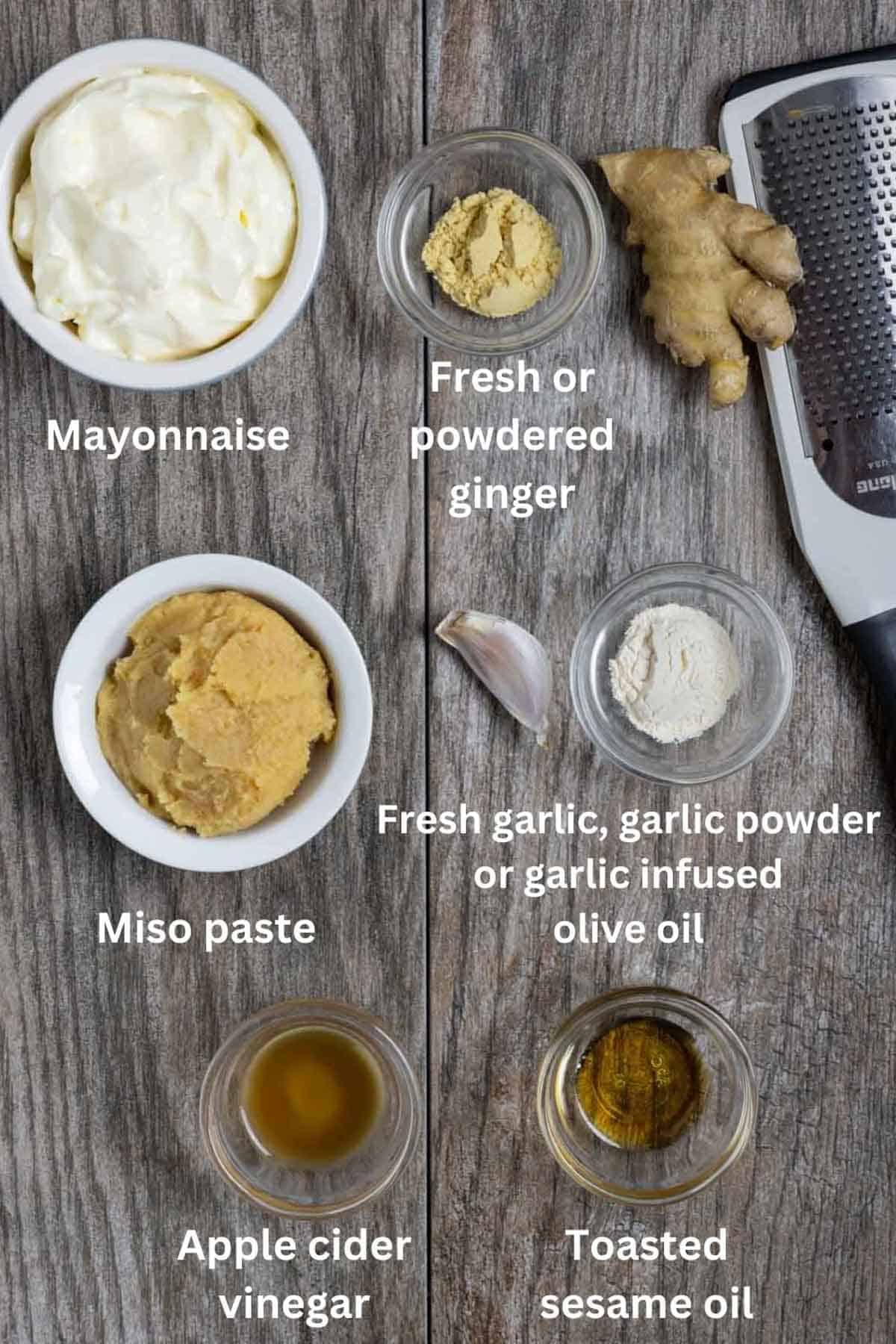 Ingredients for miso mayonnaise in small bowls on a board with white text labels.