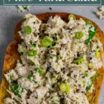 Miso tuna salad open faced on toast with bowl of sesame seeds.