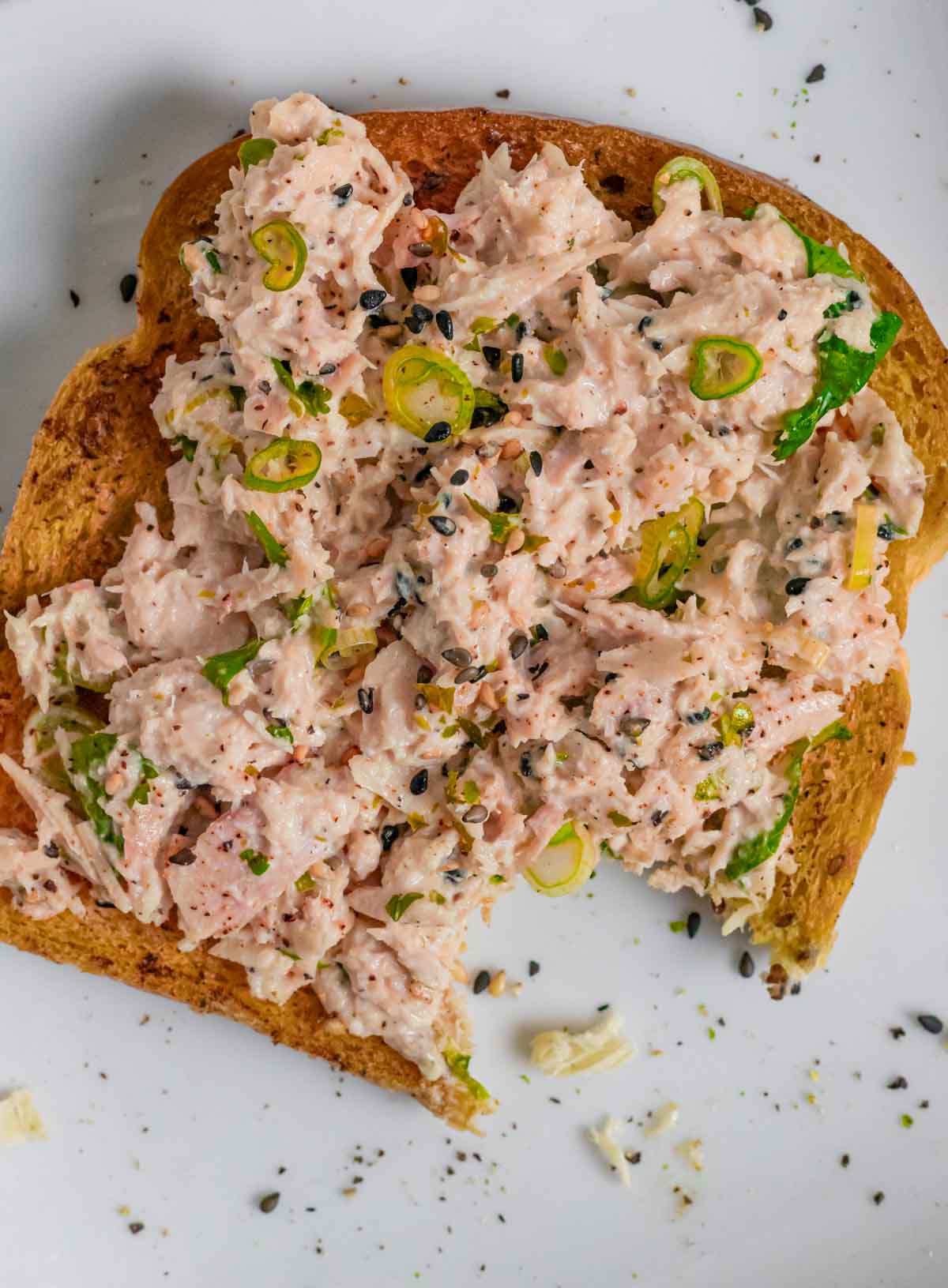 Miso tuna salad on toast with a bite out of it.