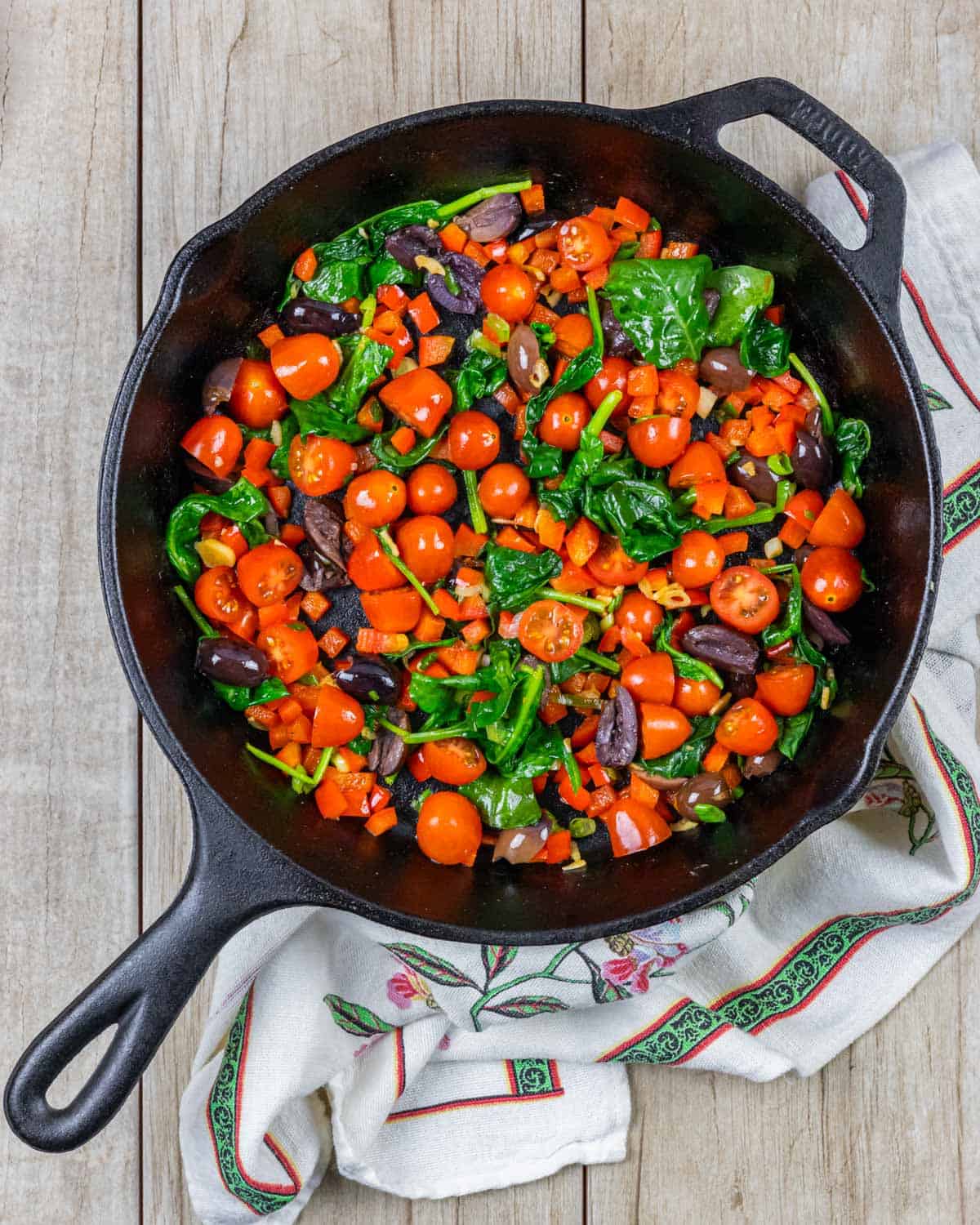 Veggies for Mediterranean stir fry sautéd in a cast iron skillet.