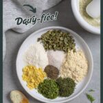 Ingredients for ranch seasoning on a white plate with a wood spoon next to it.