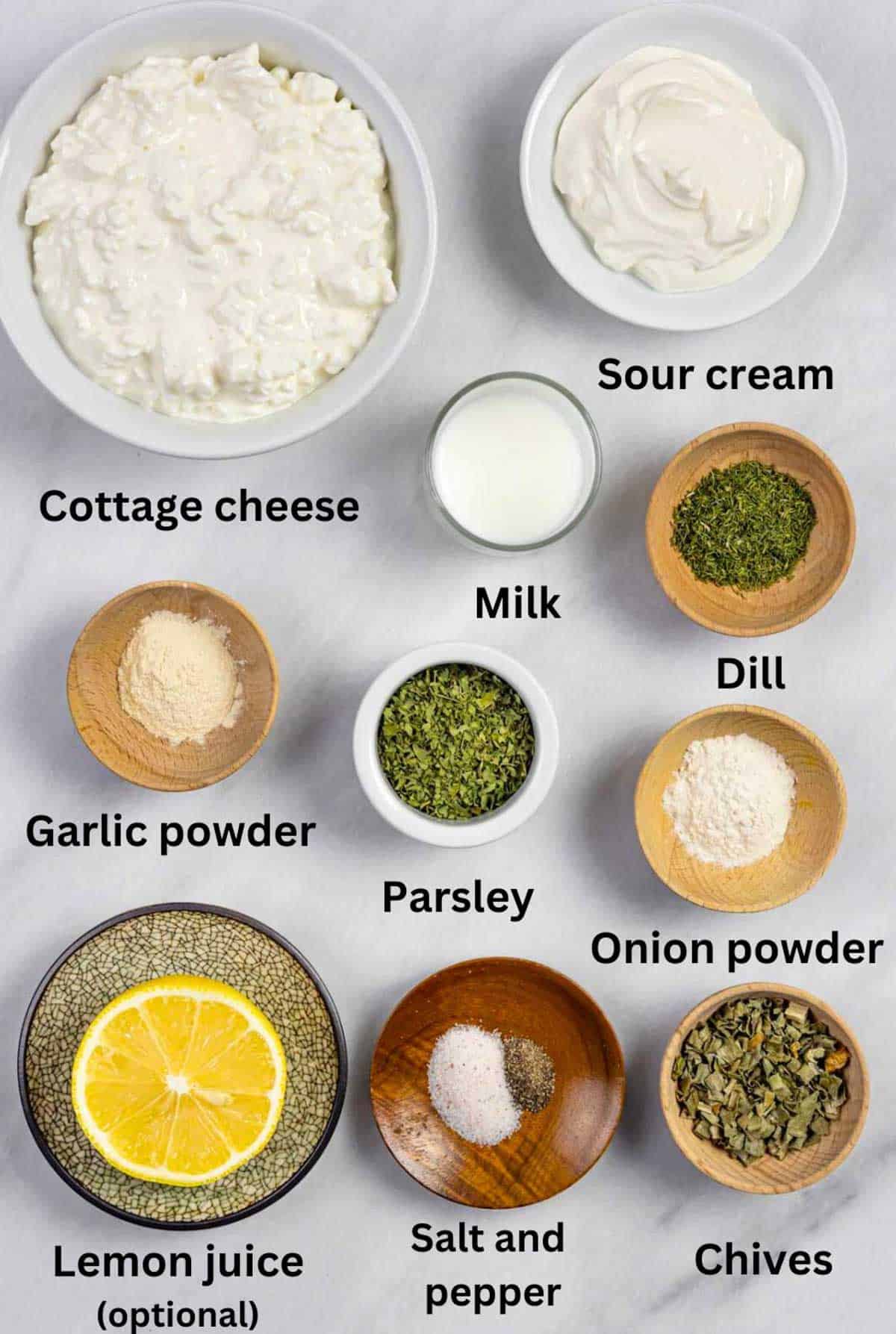 Ingredients for cottage cheese ranch dressing in small bowls with black text labels.
