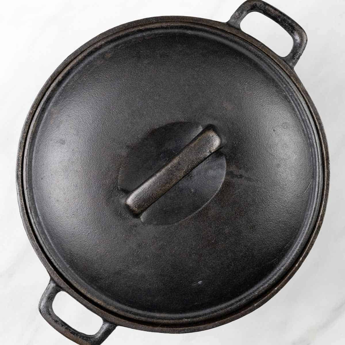 Cast iron Dutch oven with a lid on it.