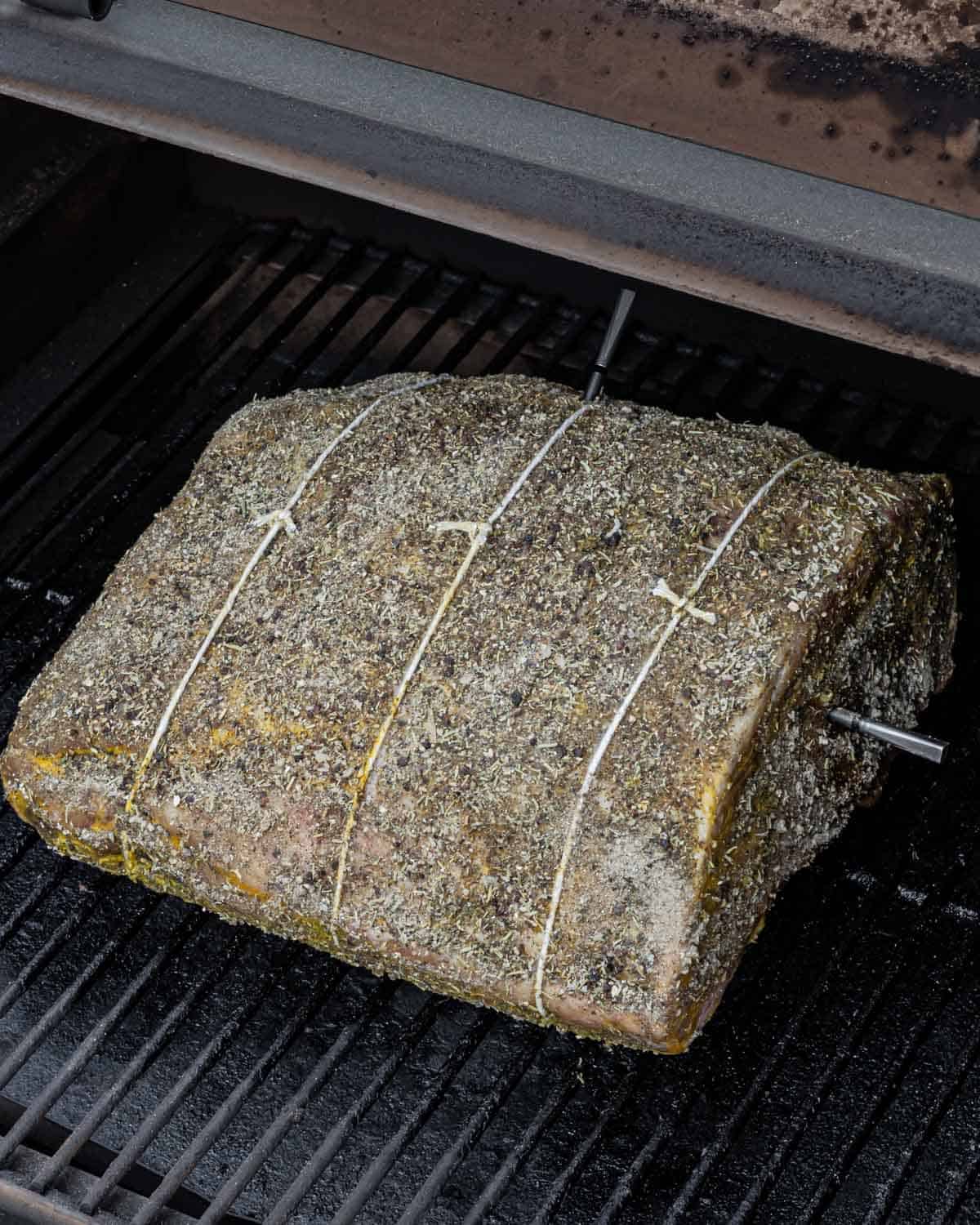 Prime rib roast on the smoker grill with wireless meat thermometers inserted
