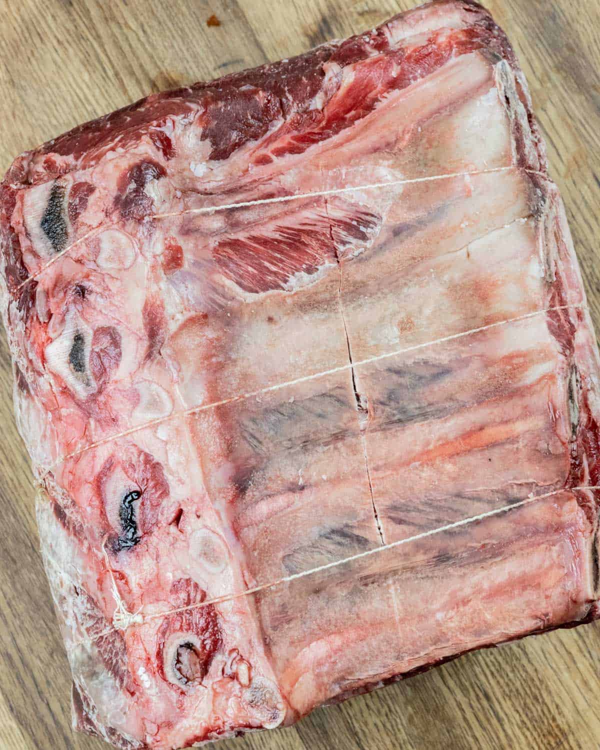 Raw prime rib roast with bones side up